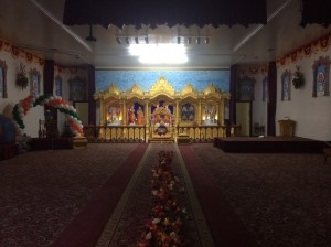 A row of flowers divides the temple down the middle. Women sit on the left, men on the right.