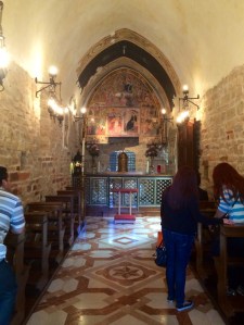 Visitors praying at the Porziuncola.